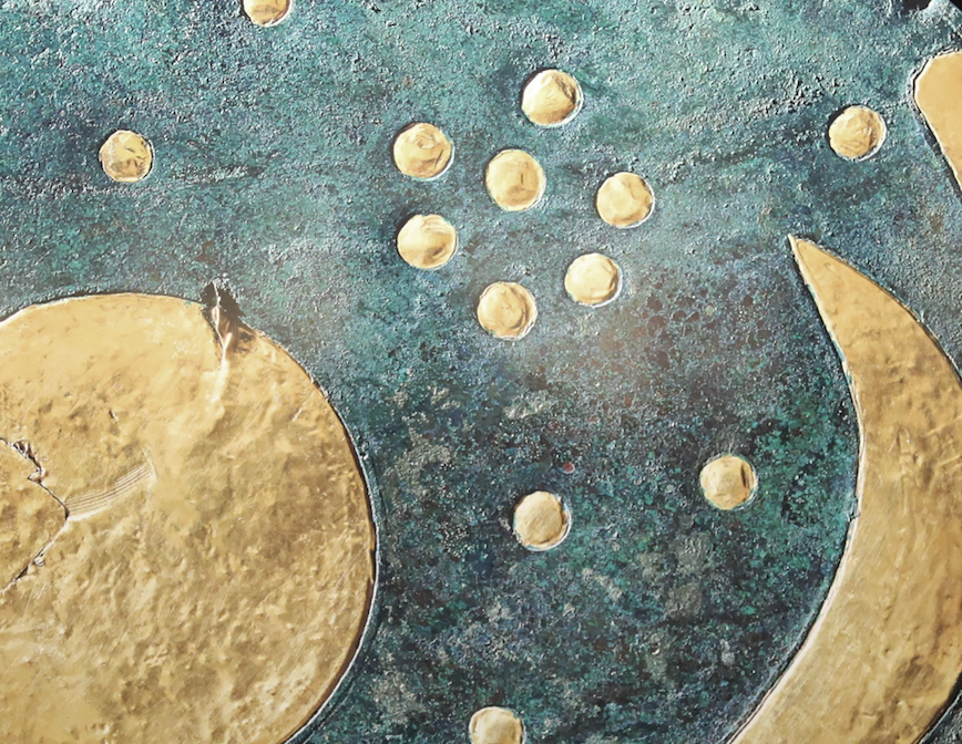 a cluster of seven gold circles against a blue-green background