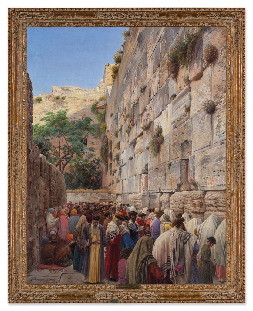 An image of men in robes praying at the Western Wall in Israel.