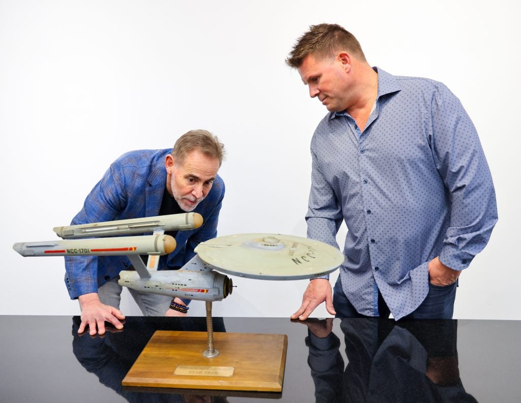 Heritage Auctions Executive Vice President Joe Maddalena, left, with Rod Roddenberry Jr, right, by the USS Enterprise.