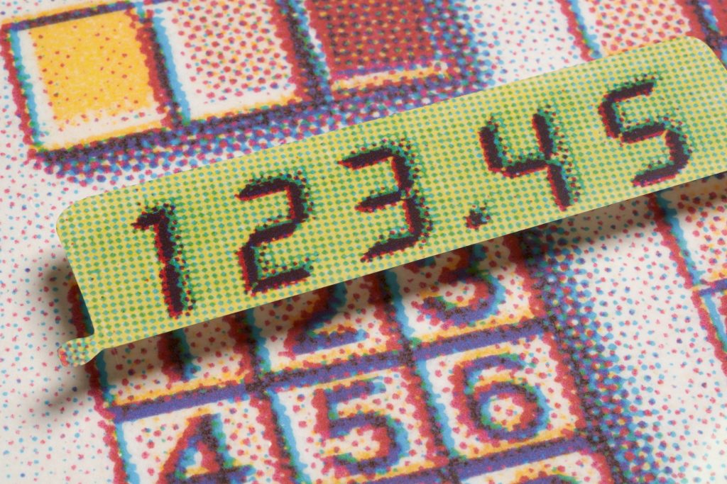 A graphic illustration of digital numbers over a computer number keypad