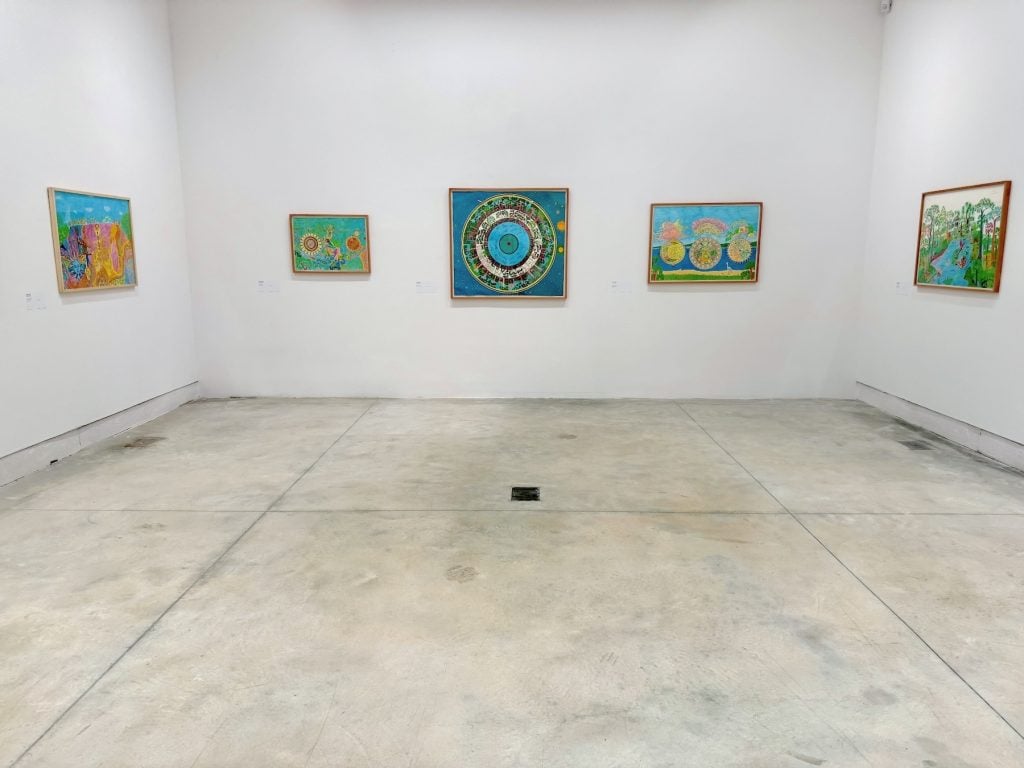 An art gallery with acrylic on paper images