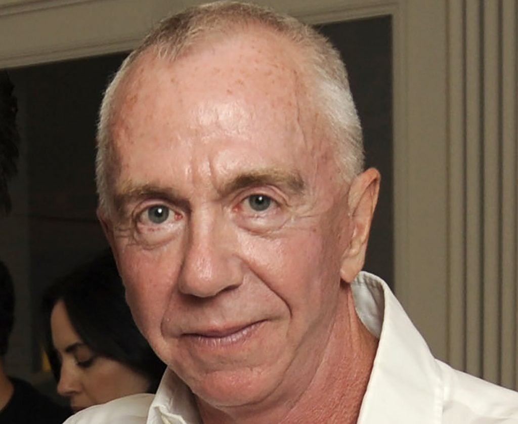 An elderly man, late gallerist Brent Sikkema, in a white shirt