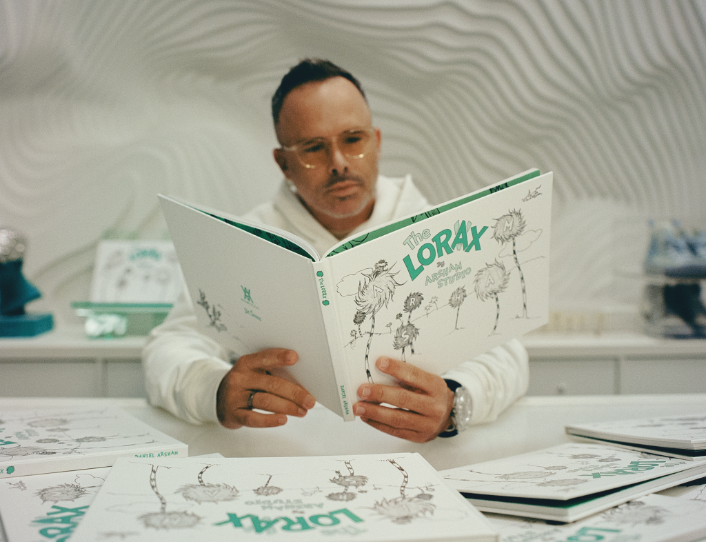 A man, sculptor Daniel Arsham, reading The Lorax