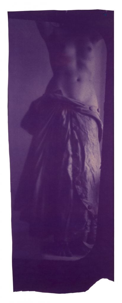 blue photograph of a woman posing as a caryatid, her face isnt visible