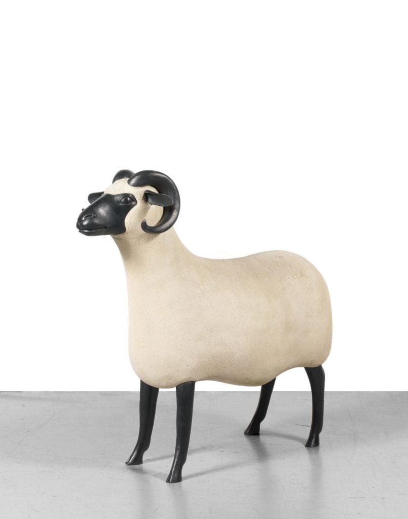 A sculpture of a ram in a gallery space.