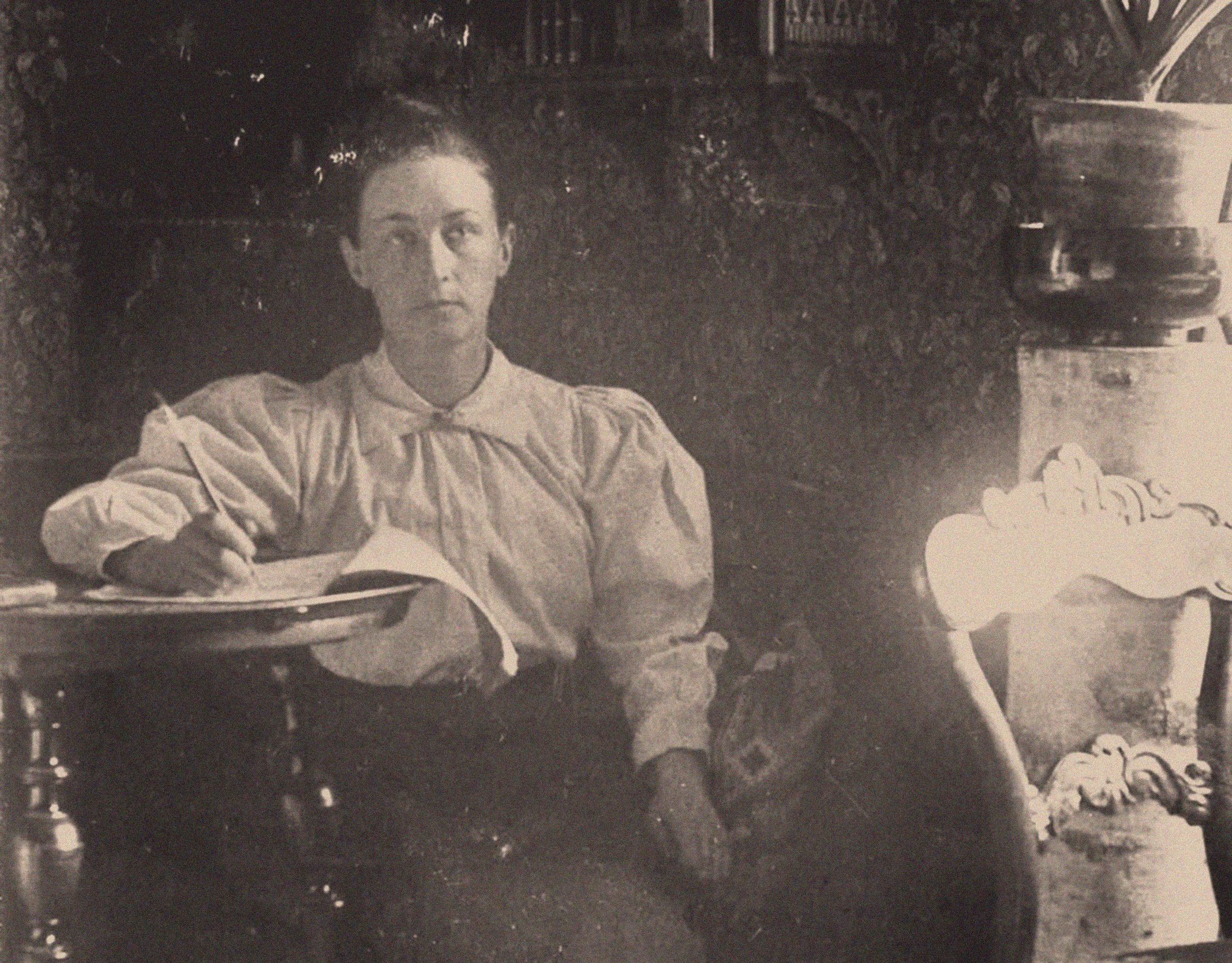 black and white photograph of a woman in a white shirt