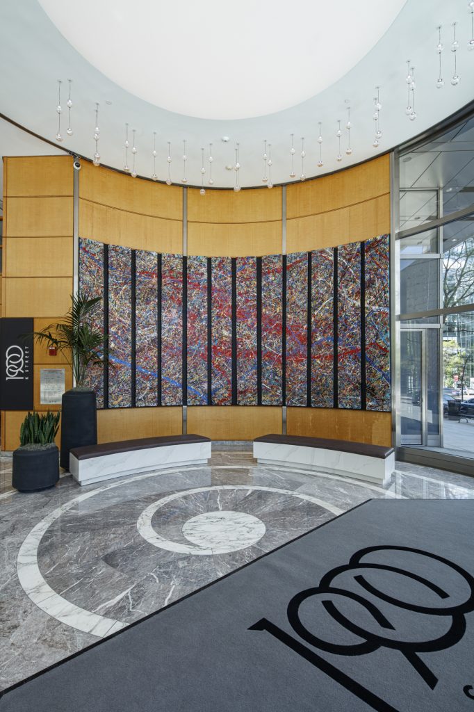 The interior of a commercial building lobby featuring a 12-panel abstract painting by Jumper Maybach.