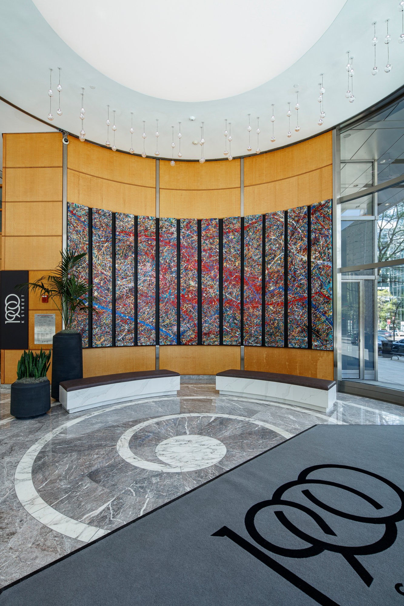 The interior of a commercial building lobby featuring a 12-panel abstract painting by Jumper Maybach.