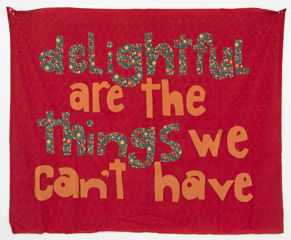 A cloth artwork that reads "delightful are the things we can't have"