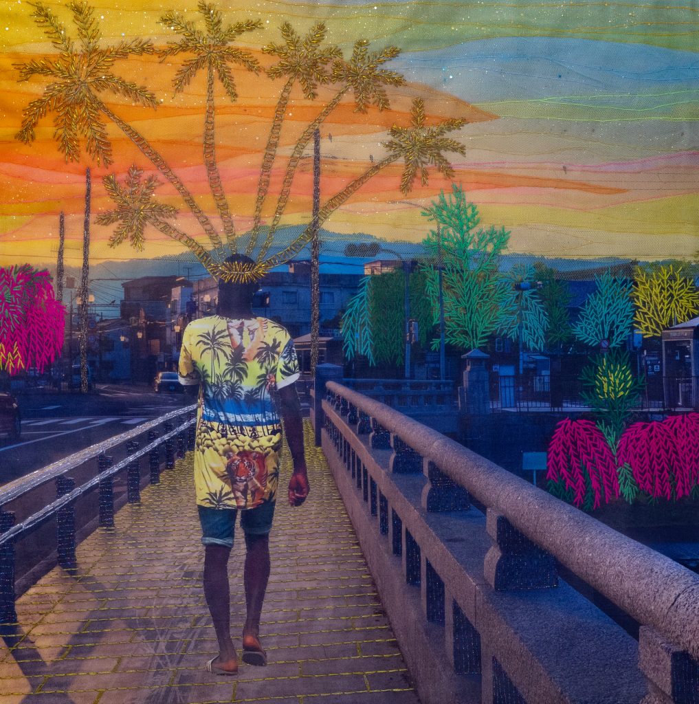 A man in a tiki tee shirt walks away down a boardwalk with a golden thread crown of oversized palm trees.