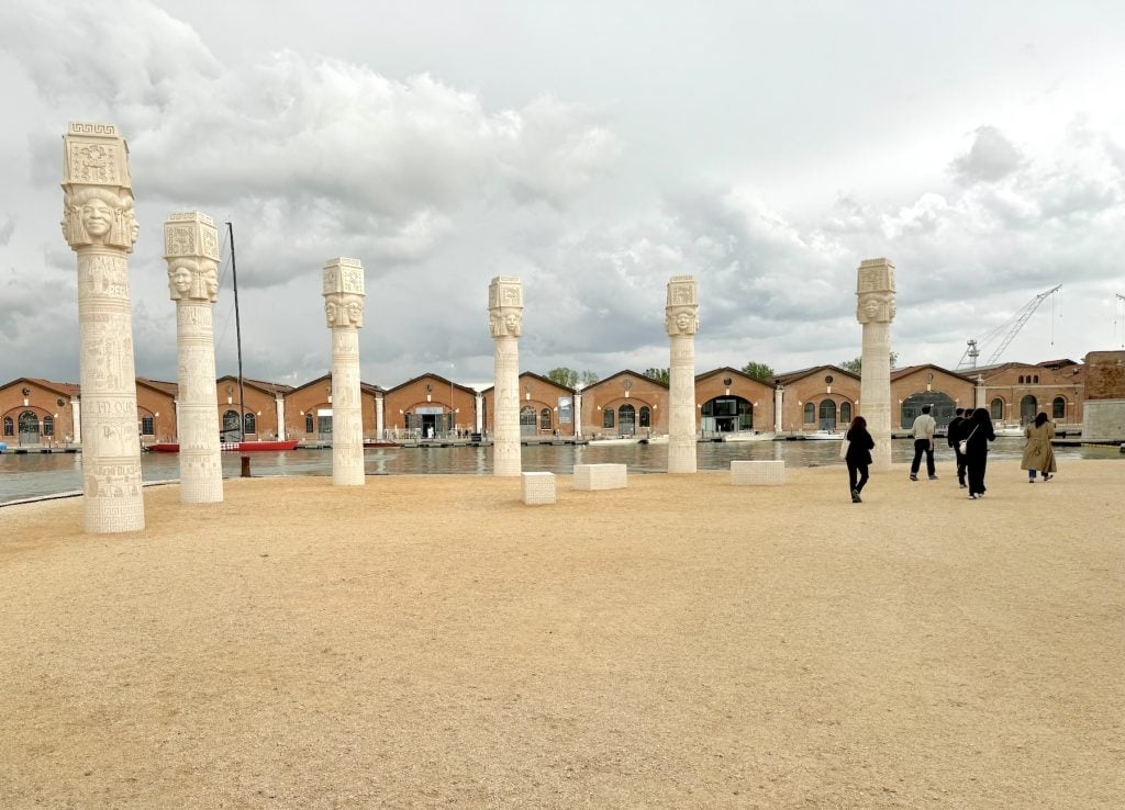 Six pillars beneath a cloudy sky