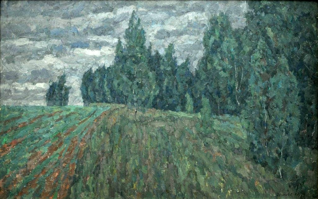 This painting presents a landscape featuring a field leading up to a dense cluster of trees. The brushwork is expressive, capturing the lush greenery and the overcast sky with dynamic strokes. There's a sense of tranquility and the rich, natural beauty of the rural environment. The painting style appears to balance between realism and impressionism, with a particular focus on the play of light and the texture of the foliage and field.