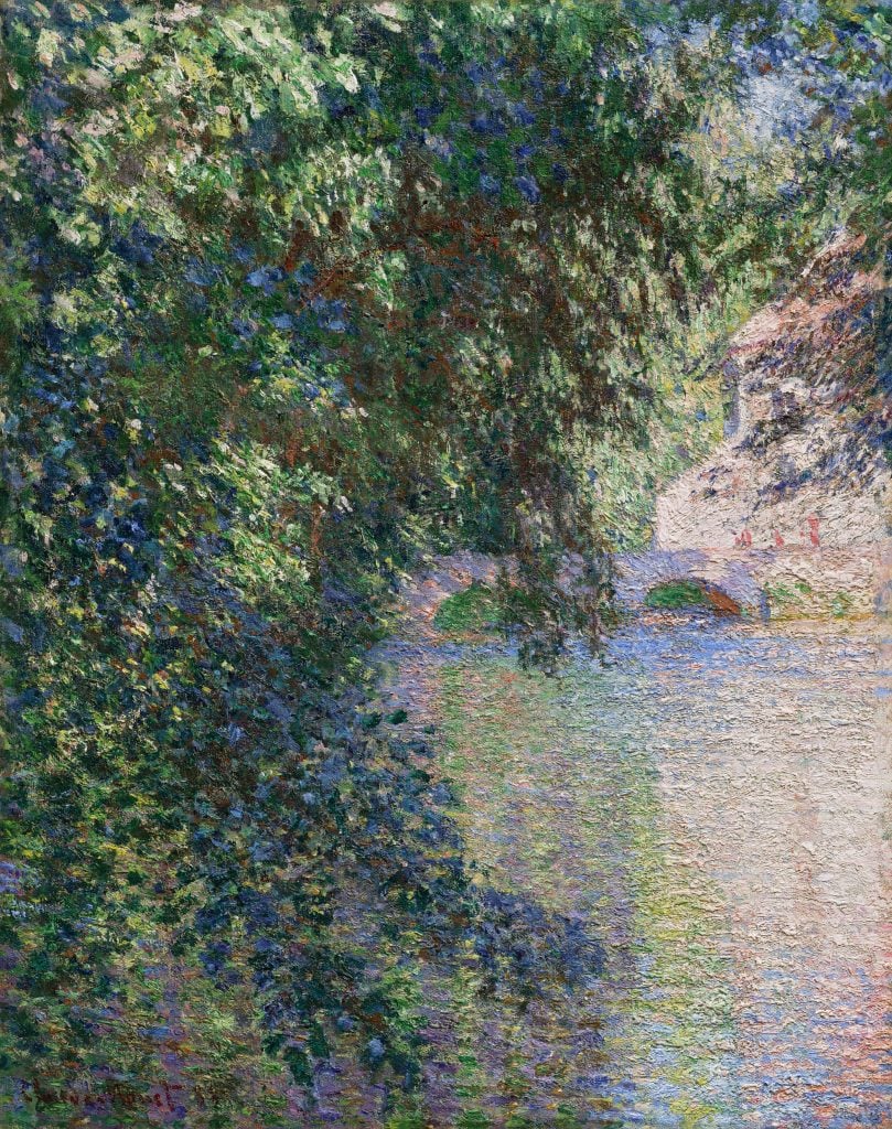 Artist Claude Monet's Impressionist painting depicting a mill framed by a crowd of leaves.