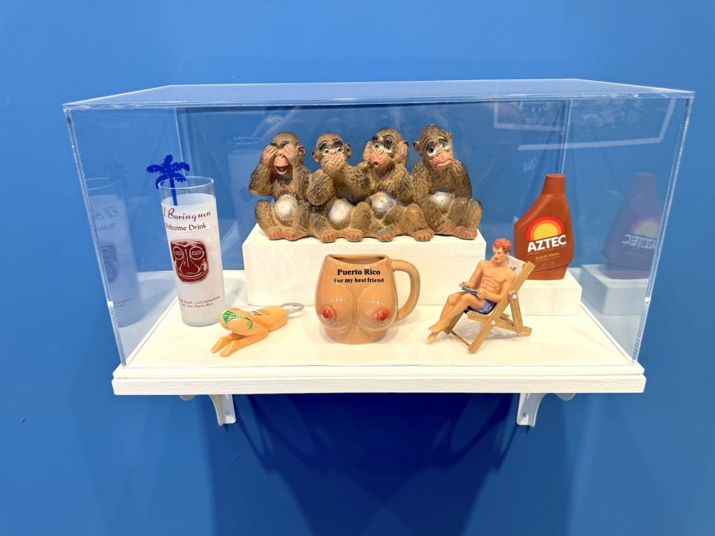 A collection of tourist souvenirs displayed under glass