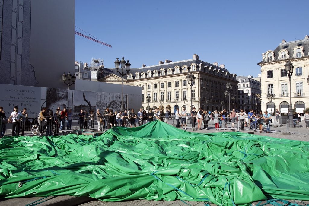 A large green tarp on a Parisian street