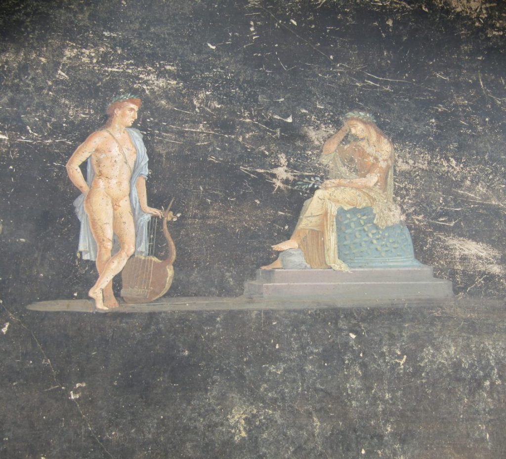 Ancient Pompeiian mural of a man, resting on a lyre, facing a seated woman with her head in her hand.