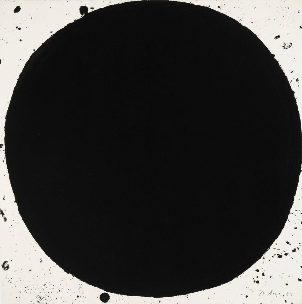 A large, opaque black dot that reaches the corner of the paper.