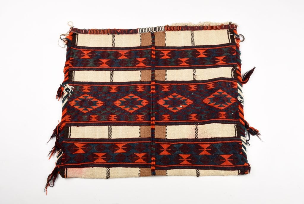 red, brown and biege Al-Sadu textiles featuring a geometric pattern made by Bedouin women.