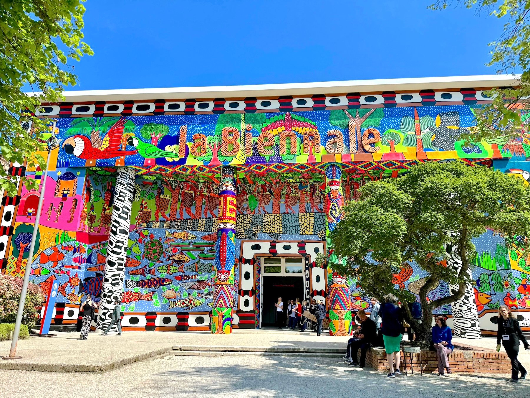 A building that says "la Biennale" covered in bright colored pattern