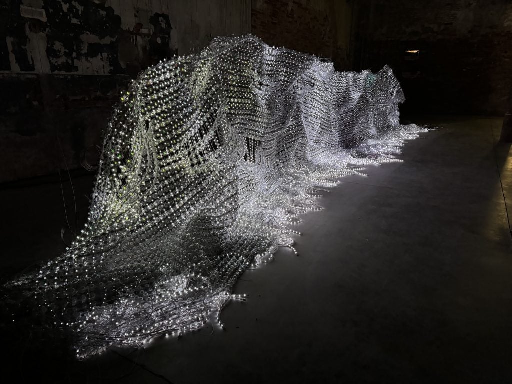 A sculpture made of a pile of glowing lights