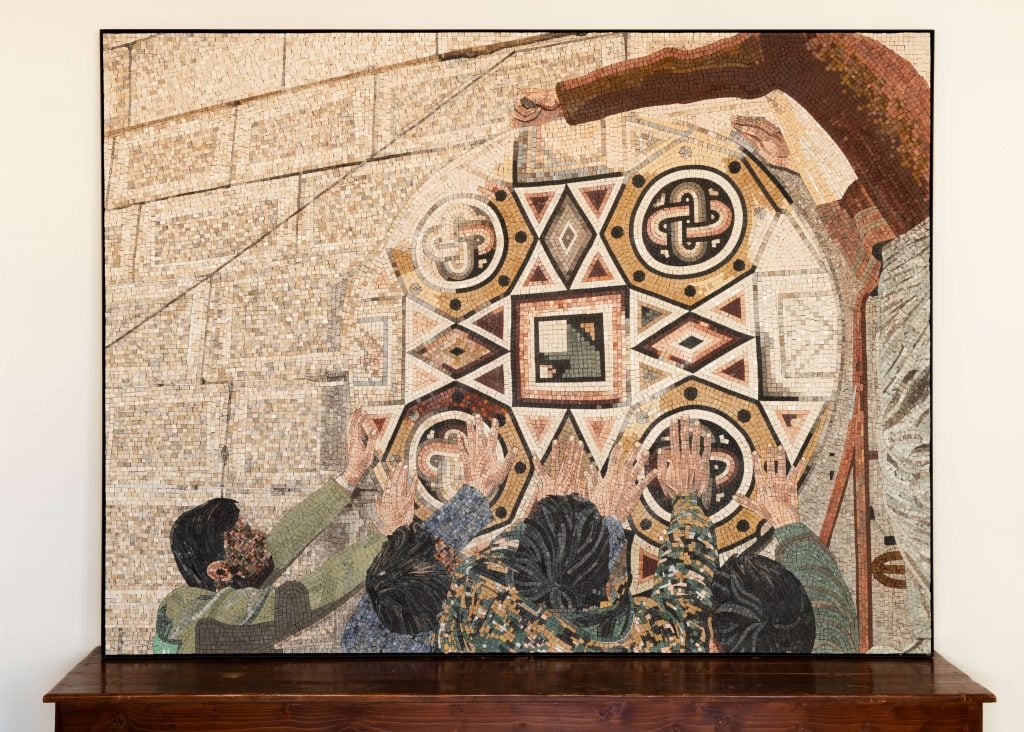A mosaic depicting a scene with multiple people, possibly in a religious or spiritual setting, with intricate geometric and symbolic designs in the background.