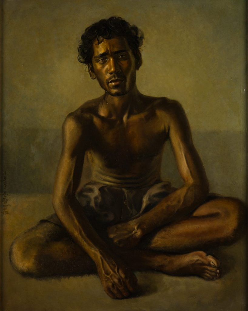 Portrait piece of a shirtless man seated cross legged.