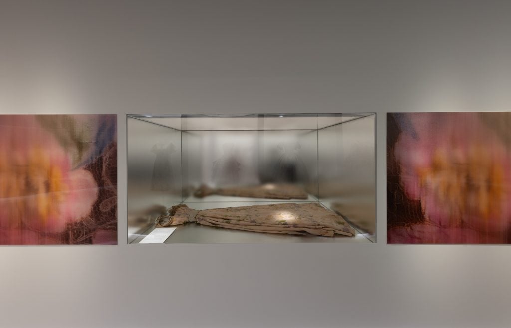 an installation view of a dress in a vitrine 