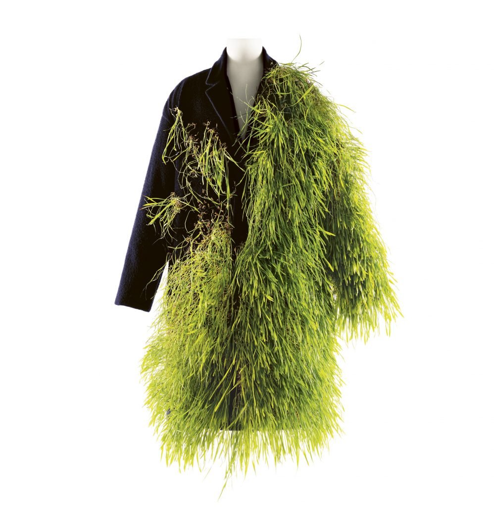a men's coat has real grass growing out of it