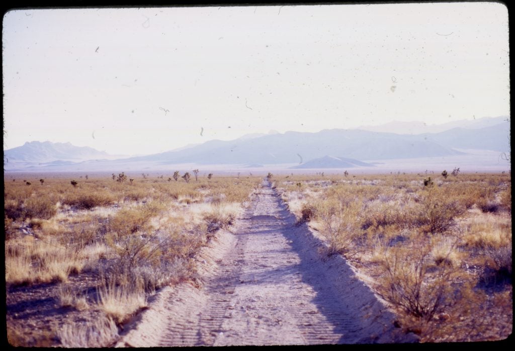 A film image of a dirt path in the desert