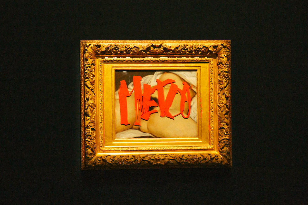 a painting marked with red pen in a gold frame