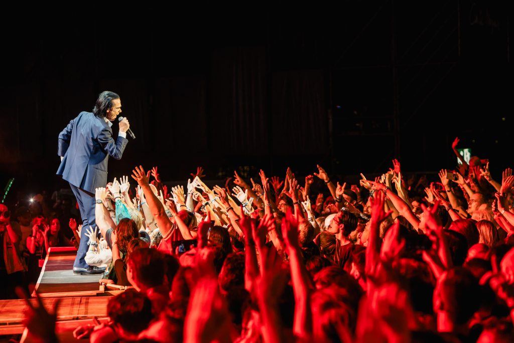 Singer Nick Cave performs in front of a huge crowd