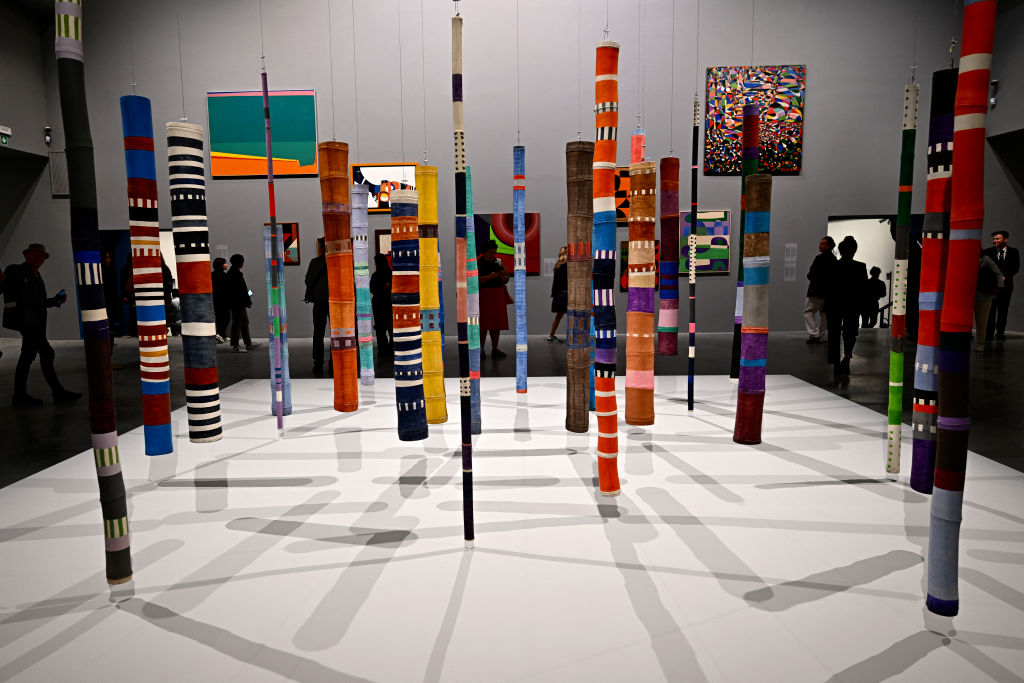 an installation of painted bamboo sticks in a museum