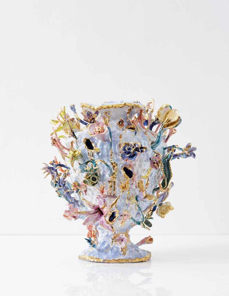an aorta-like vase in pastels with flowers emerging from its arteries painted inside with gold