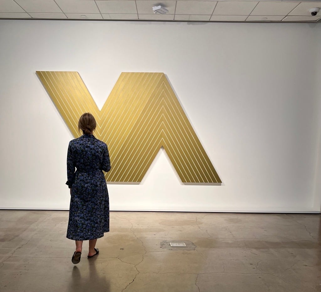 a v-shaped canvas with a viewer in front of it