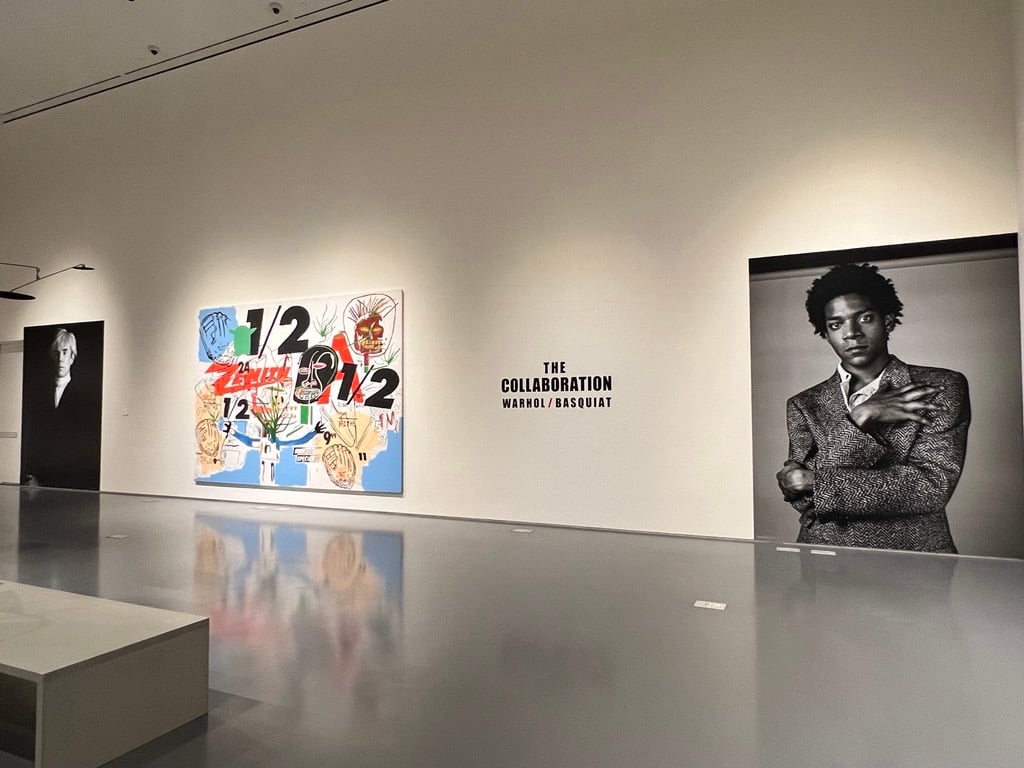 black-and-white large photos of Warhol and Basquiat flank a massive collaboration painting between the two artists
