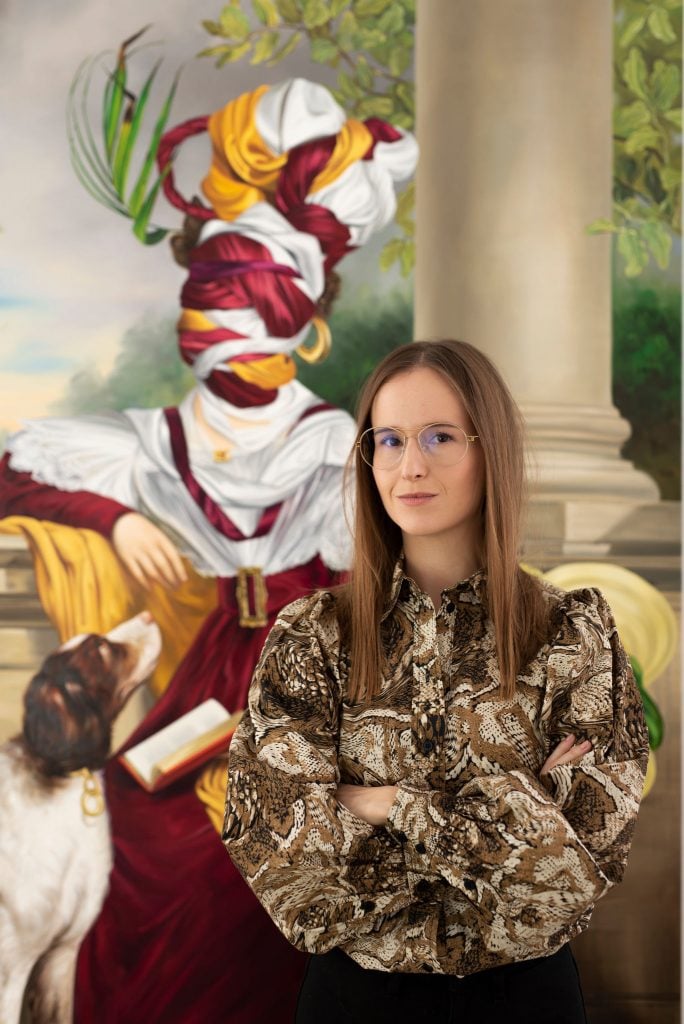 Ewa Juszkiewicz stands in front of one of her paintings