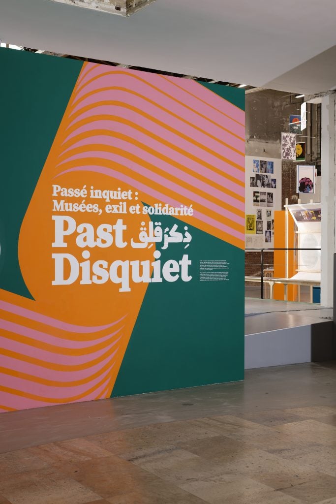 an exhibition title wall in a museum. the wall text reads Past Disquiet
