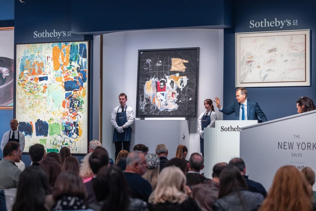 the auctioneer Oliver Barker leads the evening sale of contemporary art at Sotheby's New York