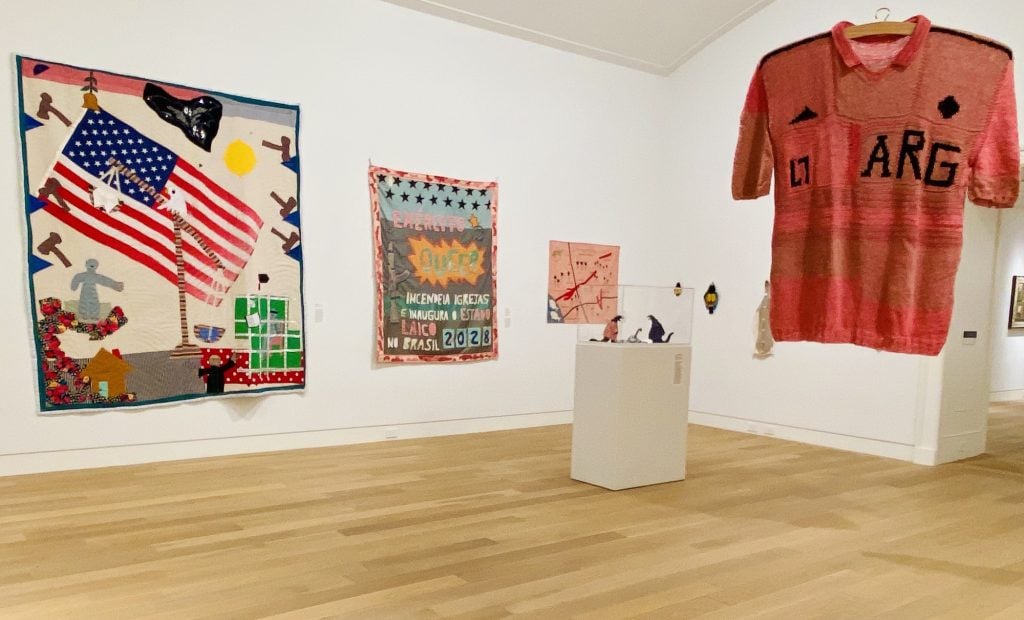 textile art featuring a woven sports jersery and wall hung tapestries