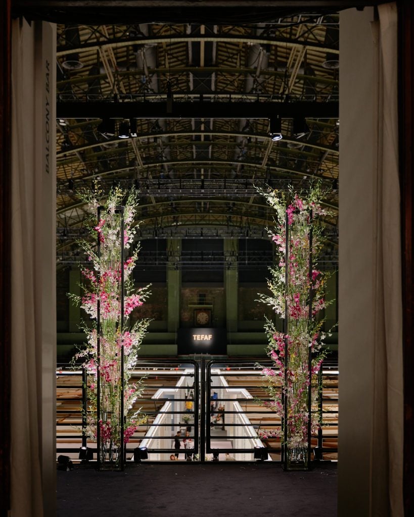 View inside TEFAF New York 2023 inside the Park Avenue Armory, shot across the tops of the exhibitor booths.