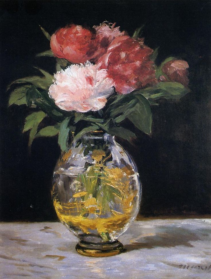In a color photo, flowers are seen in a vase against a black background.