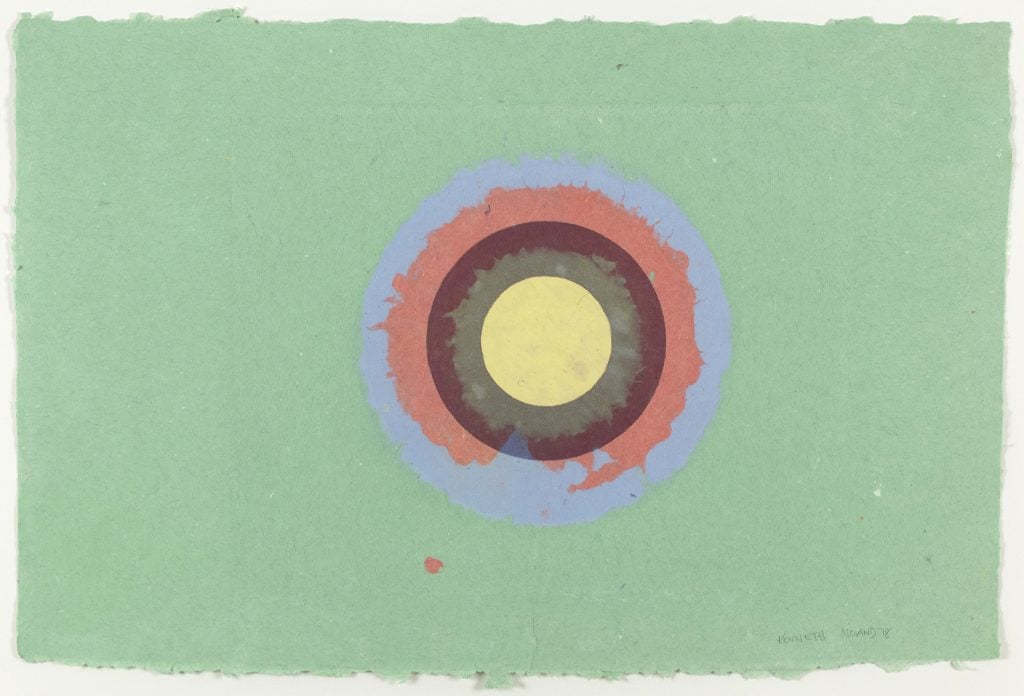 A Kenneth Noland circle composition on paper, with the circles in pink, umber, and yellow on a sea foam ground.