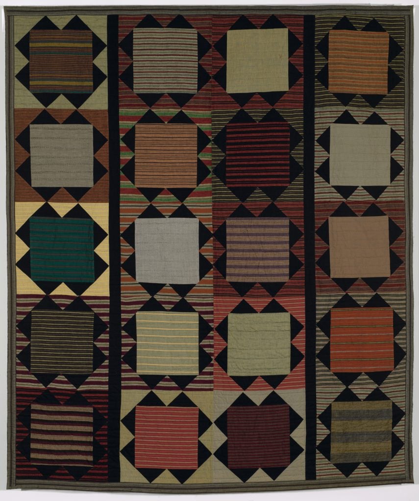 A geometrically patterned quilt made by artist Christina Ramberg.