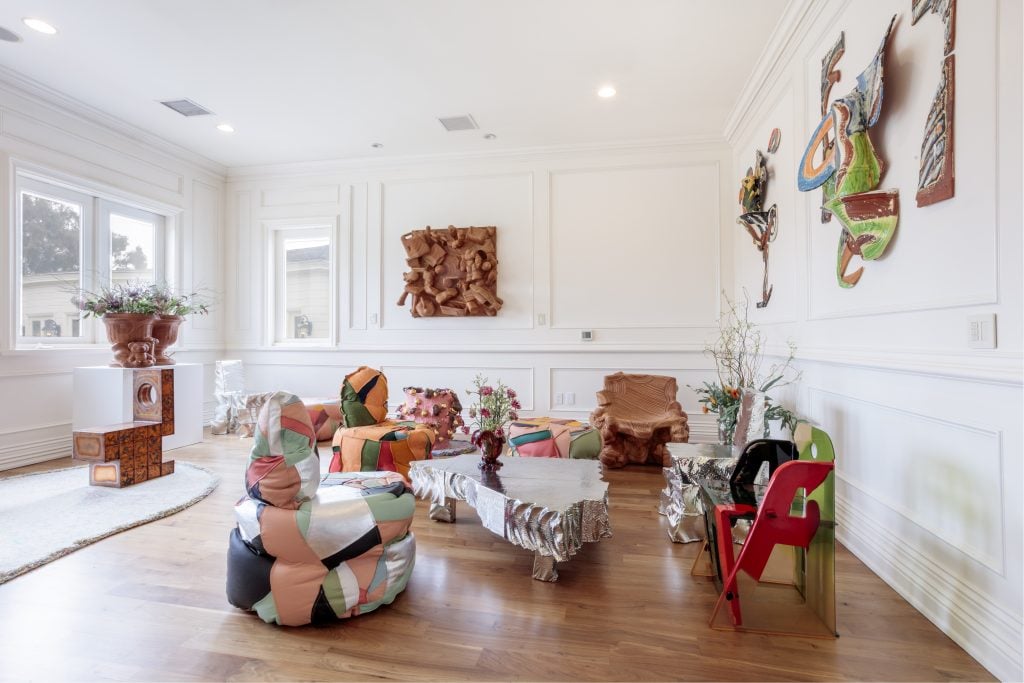 some patchwork armchairs and eclectic design collectibles fille a terracotta themed living space