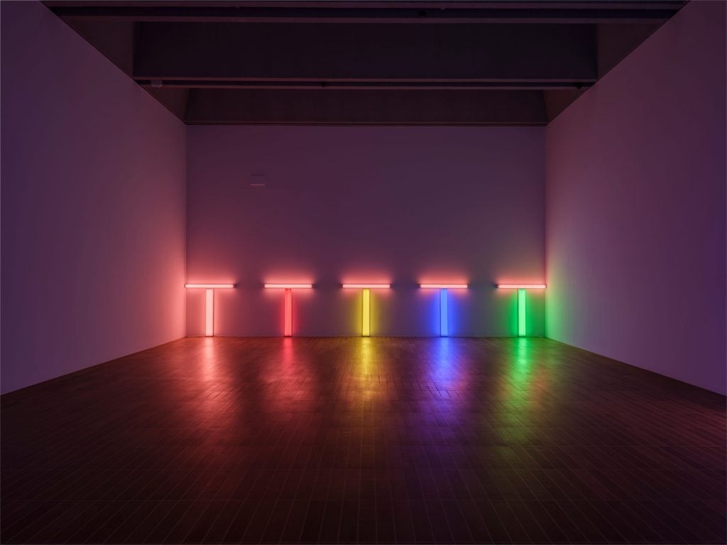 an installation featuring 5 lights in orange, red, yellow, blue, and green