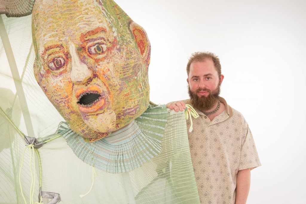 artist felix beaudry Stands next to large sculpture