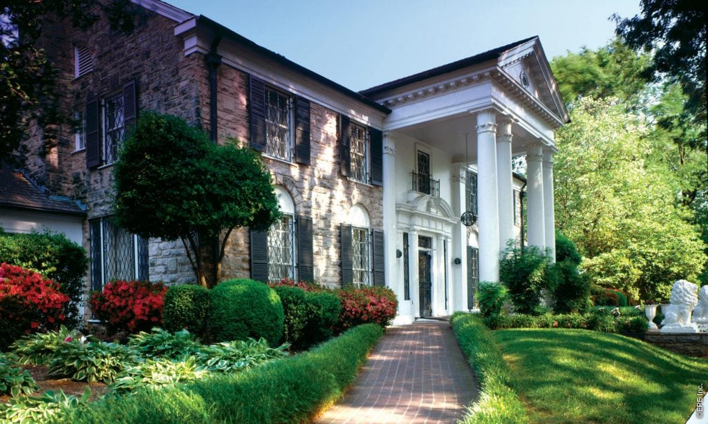 Elvis Presley's ornate Graceland mansion shown with flowering lawns