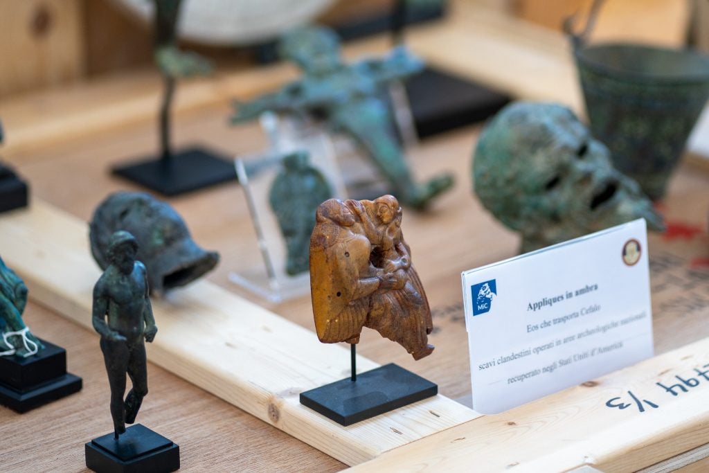 Tiny ancient sculptures arrayed on a table