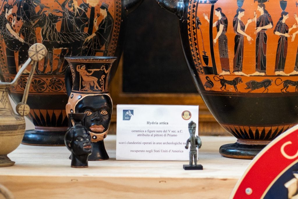 Small figurines and large vessels on a table