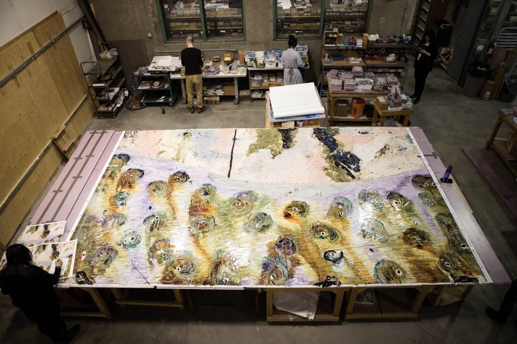 birds-eye view of a largescale mosaic piece in a studio